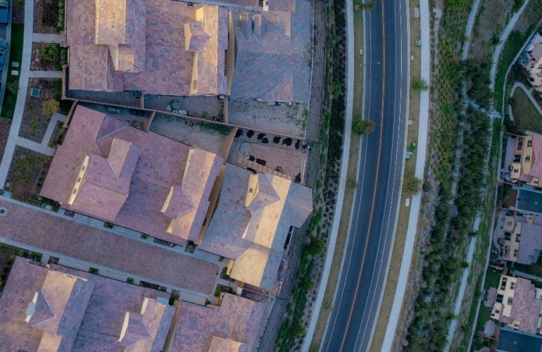 The aerial view of a highway next to neighborhood