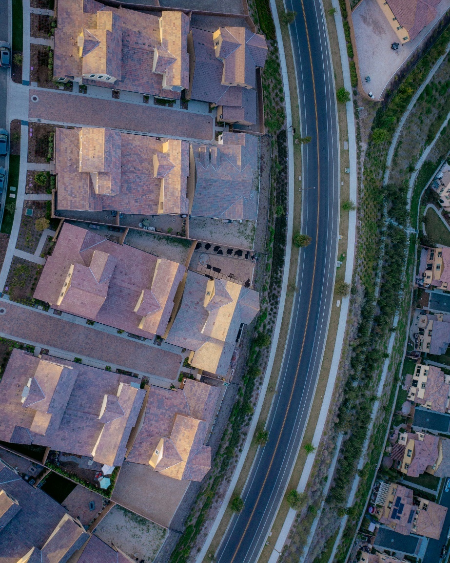 The aerial view of a highway next to neighborhood