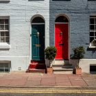 Red and green doors on matching properties.