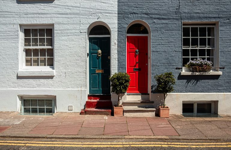 Red and green doors on matching properties.