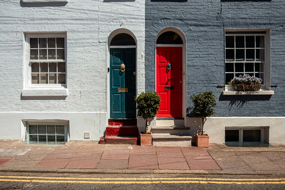 Red and green doors on matching properties.